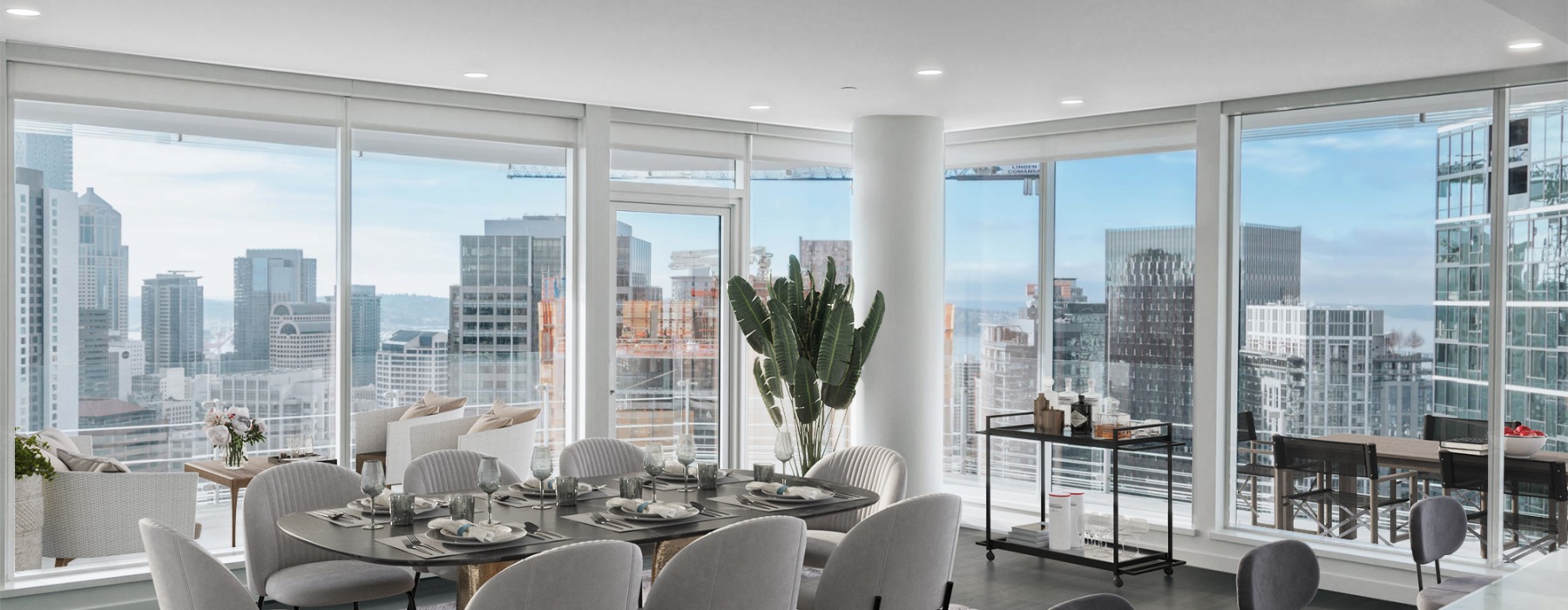 Penthouse dining room with wraparound terrace and views of the skyline and Lake Union.