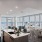Penthouse 4004 kitchen island with quartz countertops, dining area and floor to ceiling windows with private wraparound terrace and views of South Lake Union.