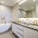 Penthouse bath with walk-in shower, additional built-in storage, deep soaking tub and floating double vanity with backlit mirror