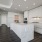 Penthouse kitchen includes island with waterfall edge, gas range, quartz countertops and upgraded appliances.