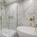 Penthouse bath with walk-in shower, additional built-in storage, deep soaking tub and floating double vanity with backlit mirror